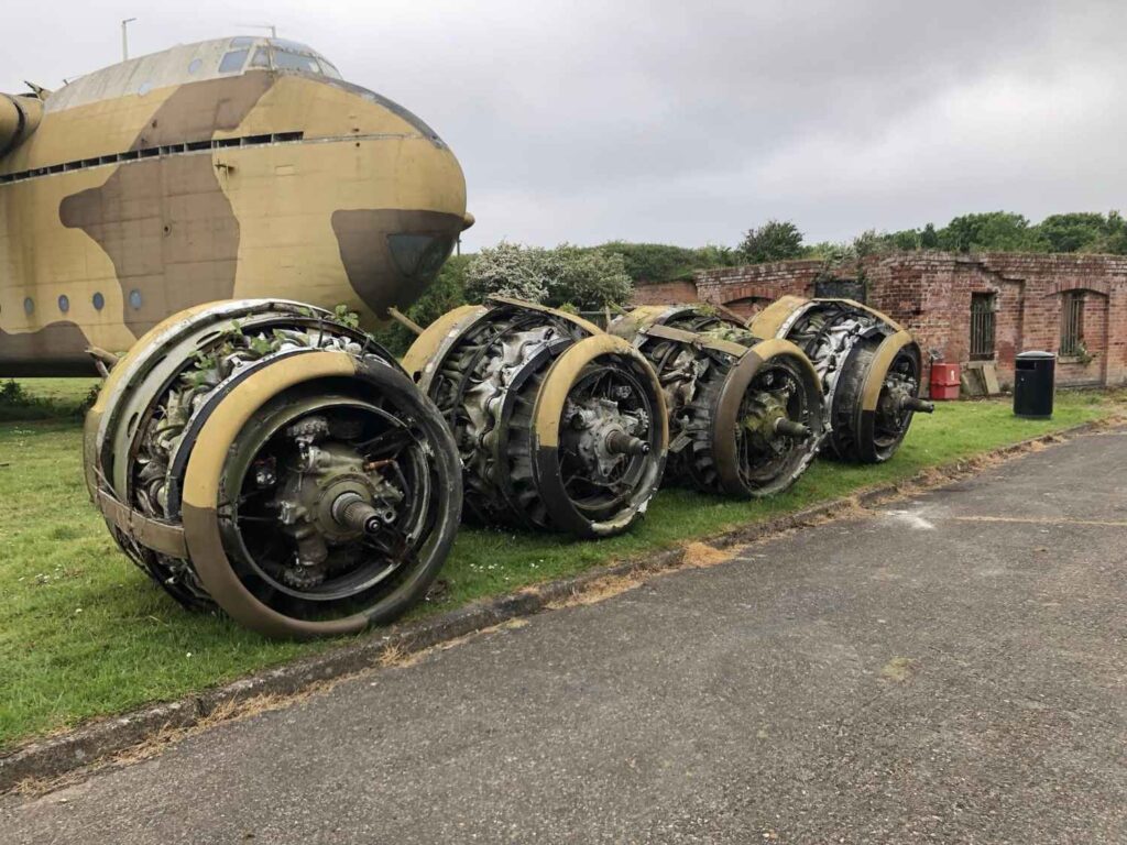 Four engines sit on the grass in front of Blackburn Beverley.