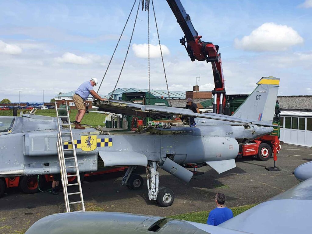 Using a crane to help reassemble the wings back onto SEPECAT Jaguar XX146 at the Solway Aviation Museum.