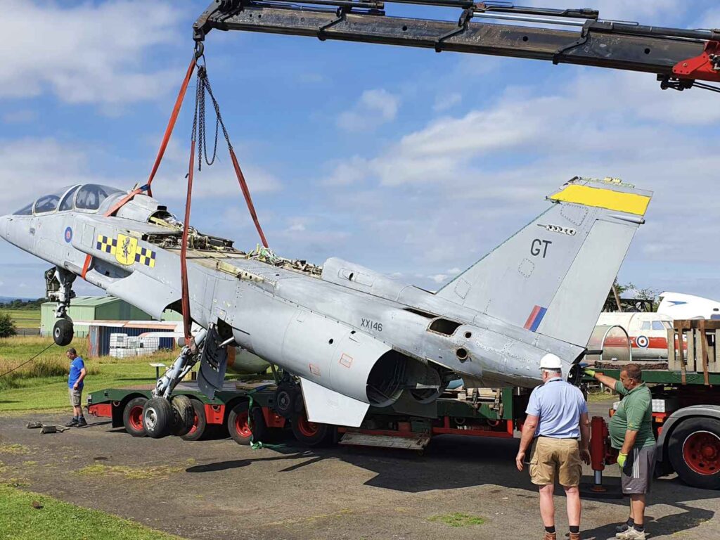 Using a crane to remove the fuselage of SEPECAT Jaguar XX146 off the trailer at the Solway Aviation Museum.