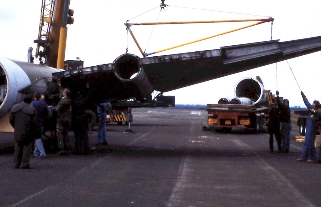 Volunteers re-attaching one of the wings to the Canberra fuselage.