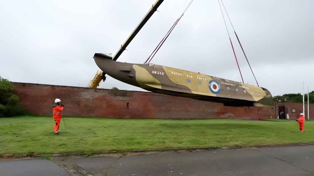 Blackburn Beverley's fuselage being lifted over the wall at Fort Paull by crane.