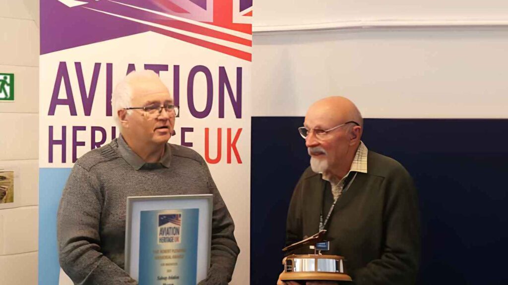 Museum chairman Dougie Kerr presented with award by Martin Withers, ex-RAF pilot.